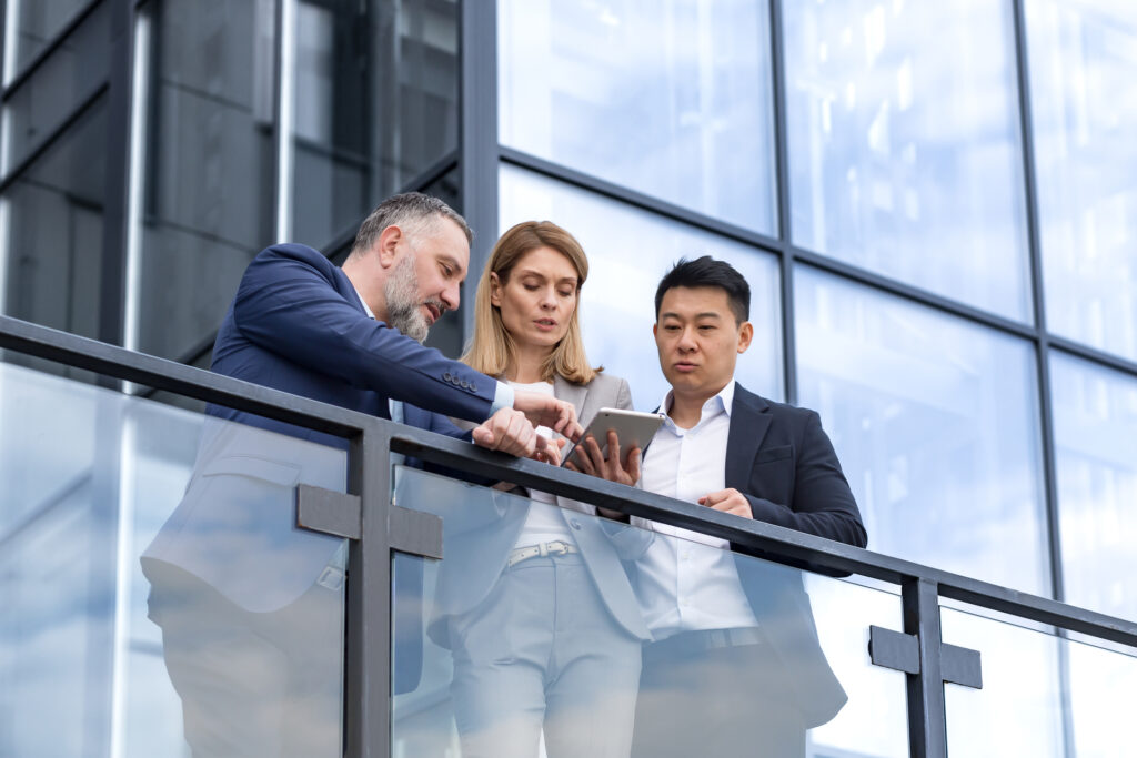 IT team leaders test app outside office with colleagues.