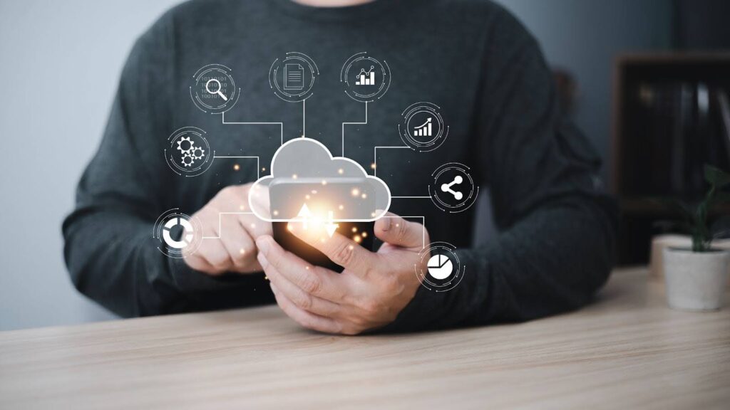 Mobile user engaging with cloud-based tools, surrounded by glowing data icons—visualizing the power and simplicity of cloud solutions for small business growth