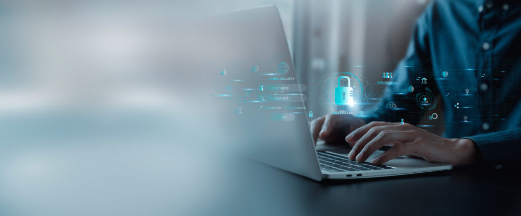 Person typing with digital cybersecurity login overlay and glowing padlock icon.